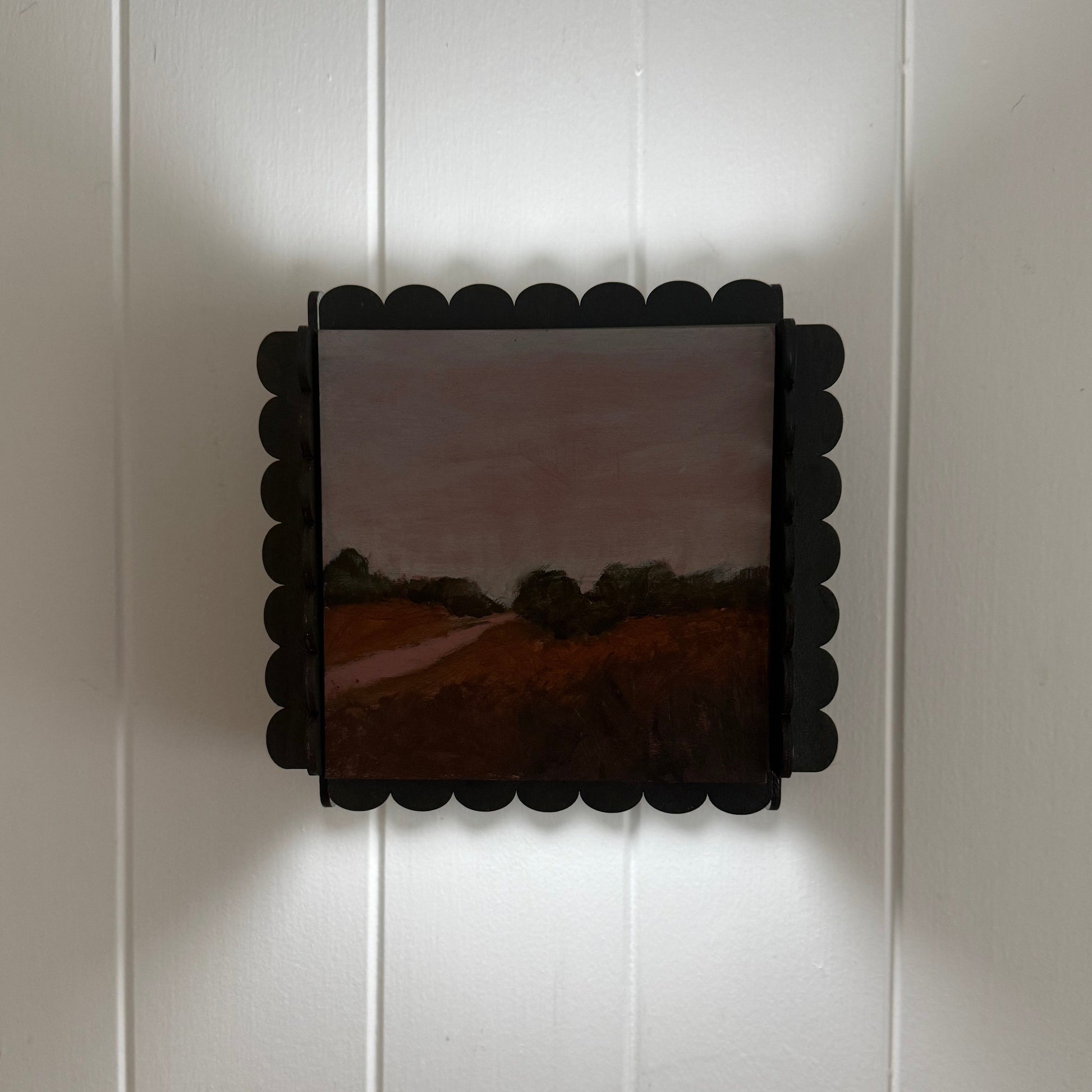 Decorative wall light fixture on a white paneled wall